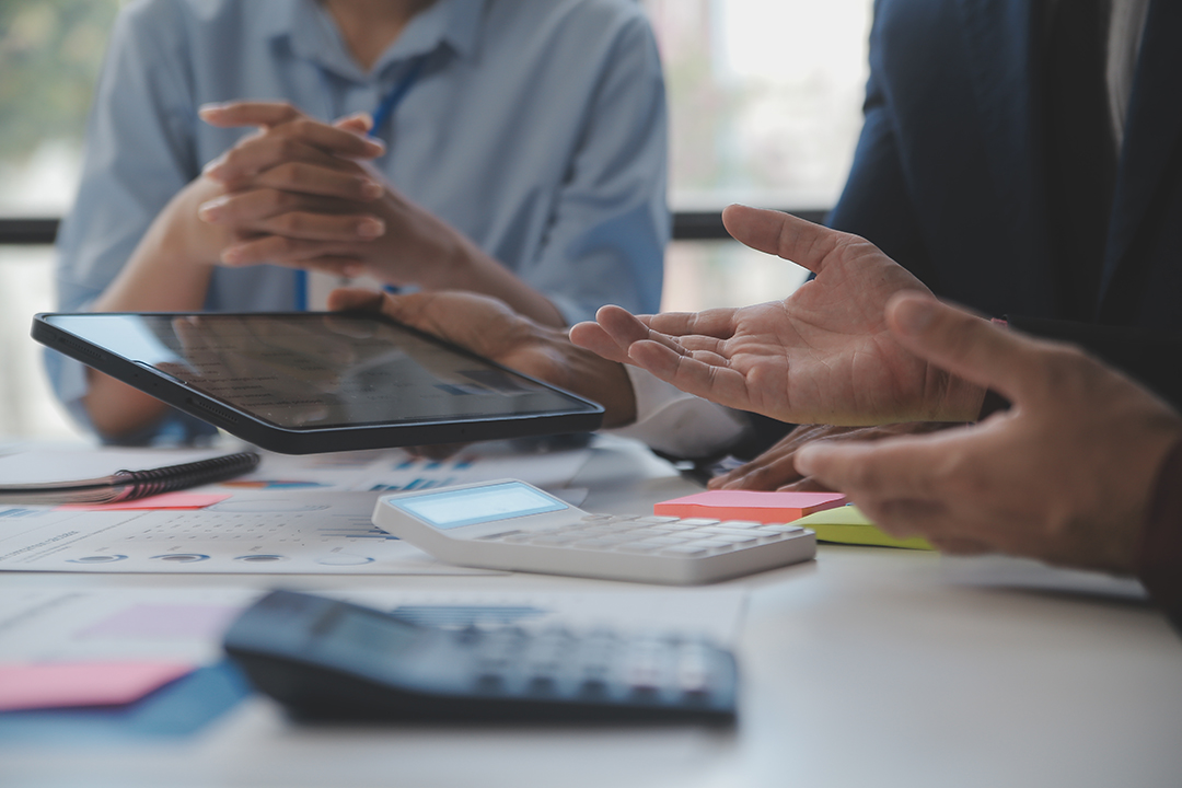 Financial analysts analyze business financial reports on a digit